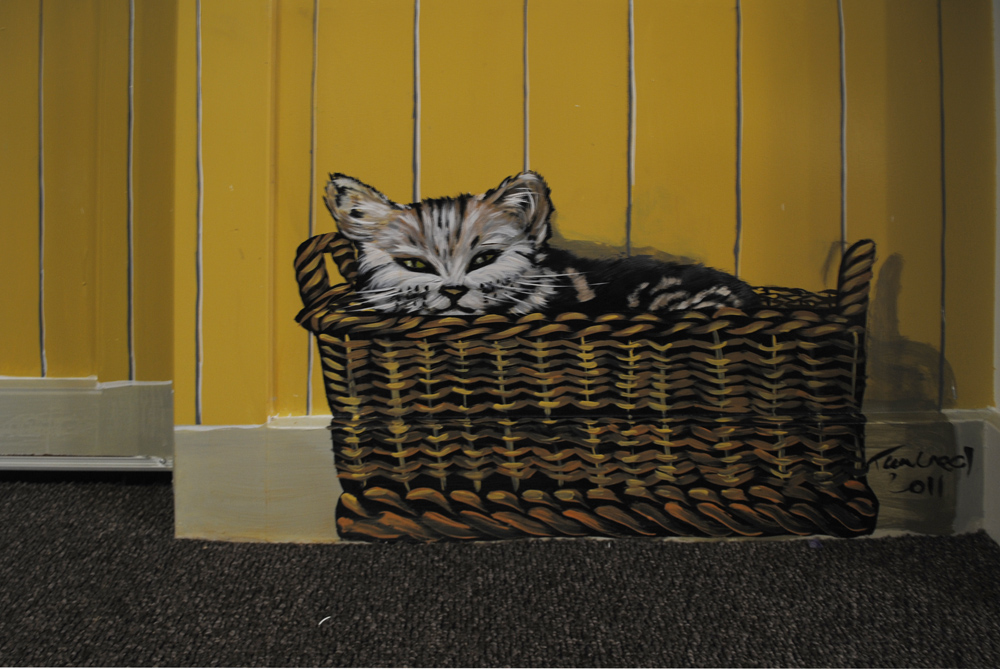 close up of cat in a basket in hand-painted dementia mural